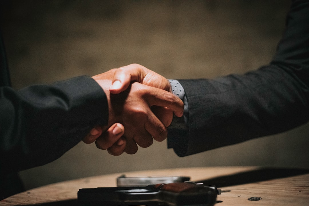 Attorney and client shaking hands after reaching a settlement agreement